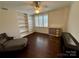 Comfortable bedroom features rich hardwood floors, built-in bookshelves, and a large window at 1300 Queens Rd # 210, Charlotte, NC 28207