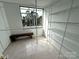 Large walk-in closet with built-in shelving and a bench under the window at 1300 Queens Rd # 210, Charlotte, NC 28207