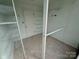 Bright walk-in closet features multiple shelves and a hanging rod for optimal storage space at 1300 Queens Rd # 210, Charlotte, NC 28207