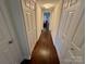 Hallway with wood floors and neutral walls, with a view of a living space at the end at 1300 Queens Rd # 210, Charlotte, NC 28207