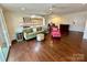 Spacious living room with dark hardwood floors, open to the kitchen, and tastefully decorated with stylish furnishings at 1300 Queens Rd # 210, Charlotte, NC 28207
