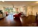 Bright living room with hardwood floors, balcony access, open to kitchen, and stylish furnishings at 1300 Queens Rd # 210, Charlotte, NC 28207