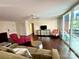 Inviting living room with hardwood floors, comfortable seating, and sliding glass doors to the outside at 1300 Queens Rd # 210, Charlotte, NC 28207