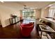 The living room offers dark hardwood floors, balcony access, an open kitchen view, and contemporary furniture at 1300 Queens Rd # 210, Charlotte, NC 28207