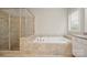 This large bathroom has a separate shower and soaking tub with tile surround and good natural light at 13044 Fen Ct, Huntersville, NC 28078