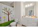 Bright bathroom featuring a vanity with cabinets, a large mirror and a shower with a tree-themed shower curtain at 13044 Fen Ct, Huntersville, NC 28078