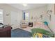 This bedroom is decorated with a chair, name graphics, and a blue rug at 13044 Fen Ct, Huntersville, NC 28078