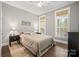Cozy bedroom featuring hardwood floors, neutral walls, and large windows with plantation shutters for optimal light control at 13044 Fen Ct, Huntersville, NC 28078