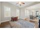 Versatile bonus room with a ceiling fan, two windows, and seamlessly flows into the dining area, perfect for Gathering fun at 13044 Fen Ct, Huntersville, NC 28078