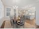 Bright dining area showcases a wooden table and chandelier with seamless transition to the kitchen and living room at 13044 Fen Ct, Huntersville, NC 28078