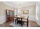 Traditional dining room with hardwood floors, wainscoting, and a classic chandelier at 13044 Fen Ct, Huntersville, NC 28078