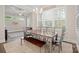 Sunlit dining room boasts large windows, seating for six, and natural light. The perfect place to enjoy meals at 13044 Fen Ct, Huntersville, NC 28078