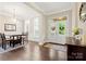 Elegant foyer with hardwood floors, chandelier, and double doors leading outside at 13044 Fen Ct, Huntersville, NC 28078