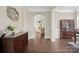 Welcoming foyer featuring dark wood floors, large mirror, and an arched entry to the living area at 13044 Fen Ct, Huntersville, NC 28078