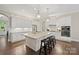 Bright, open kitchen with a large granite island, pendant lights, and stainless steel appliances at 13044 Fen Ct, Huntersville, NC 28078