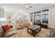 Open-concept living room flows into the kitchen, featuring large windows and hardwood floors at 13044 Fen Ct, Huntersville, NC 28078