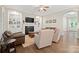 Comfortable living room showcasing fireplace, built-in shelving, and hardwood floors at 13044 Fen Ct, Huntersville, NC 28078