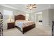 Bright main bedroom featuring neutral paint, a ceiling fan, and an adjoining sitting room at 13044 Fen Ct, Huntersville, NC 28078