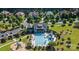 Aerial view of a community clubhouse, pool and playground with mature landscaping at 13044 Fen Ct, Huntersville, NC 28078