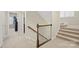 Carpeted staircase with wooden banister and white trim, leading to an upstairs level at 13044 Fen Ct, Huntersville, NC 28078