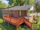 Exterior view of a brick home with a spacious wooden back deck and staircase at 1337 Eastside Ave, Albemarle, NC 28001