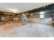Unfinished basement with concrete floor, exposed ducts, and utility connections ready for customization and storage at 1337 Eastside Ave, Albemarle, NC 28001