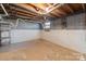 Clean unfinished basement with painted block walls, offering potential for storage or customization at 1337 Eastside Ave, Albemarle, NC 28001