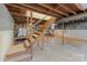 Spacious basement with exposed beams, concrete floors, and unfinished walls presents a versatile space for customization at 1337 Eastside Ave, Albemarle, NC 28001
