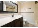 Well-lit bathroom features tile flooring, a large mirror, and a vanity with a modern sink and faucet at 1337 Eastside Ave, Albemarle, NC 28001
