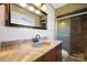 Modern bathroom with marbled countertops, updated fixtures, and glass door shower enclosure at 1337 Eastside Ave, Albemarle, NC 28001