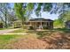 Inviting brick home with a classic covered porch and carport at 1337 Eastside Ave, Albemarle, NC 28001