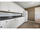 Efficient kitchen layout with bright white cabinets and sleek countertops at 1337 Eastside Ave, Albemarle, NC 28001