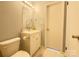 Bright bathroom with a white vanity, toilet, and a mirror with light fixture above at 1407 Clarksville Campground Rd, Monroe, NC 28112