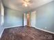 Large bedroom with hardwood floors, blue walls, and a door open into another room at 1407 Clarksville Campground Rd, Monroe, NC 28112