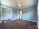 Empty bedroom with hardwood floors, a closet, a ceiling fan, and blue walls at 1407 Clarksville Campground Rd, Monroe, NC 28112