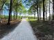 Single-story house with lots of trees and a gravel driveway at 1407 Clarksville Campground Rd, Monroe, NC 28112