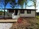 Charming single-story home with white painted brick and a quaint front porch at 1407 Clarksville Campground Rd, Monroe, NC 28112