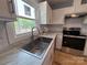 Stainless steel sink and faucet under window offer a modern kitchen feature at 1407 Clarksville Campground Rd, Monroe, NC 28112