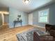 Inviting living room with hardwood floors, console table, and a view into the entryway at 1407 Clarksville Campground Rd, Monroe, NC 28112