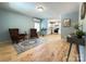Bright living room with hardwood floors, stylish chairs, and a view into the modern kitchen at 1407 Clarksville Campground Rd, Monroe, NC 28112