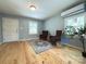 Cozy living room featuring hardwood floors, comfortable chairs, and abundant natural light at 1407 Clarksville Campground Rd, Monroe, NC 28112