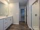 Bright bathroom featuring a glass shower, wood-look floors, and a modern vanity with plenty of cabinet space at 142 Aberdeen Dr, Salisbury, NC 28144