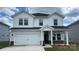 Charming two-story home featuring a two-car garage, a covered entryway, and a well-manicured lawn at 142 Aberdeen Dr, Salisbury, NC 28144