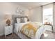 A bright bedroom featuring a decorative wall arrangement above a stylish upholstered bed with a yellow patterned comforter at 143 Shepherds Landing Dr, Mooresville, NC 28115