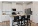 Modern kitchen with white cabinetry, stainless steel appliances, granite countertops, and a stylish breakfast bar at 143 Shepherds Landing Dr, Mooresville, NC 28115