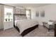 Serene primary bedroom with plush carpeting, neutral décor, large windows, and elegant furnishings for a relaxing retreat at 143 Shepherds Landing Dr, Mooresville, NC 28115