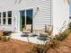 Cozy patio with two wicker chairs and small table on the patio, overlooking the yard at 143 Shepherds Landing Dr, Mooresville, NC 28115
