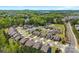 Lush aerial view of a suburban community with tree coverage and a lake in the distance at 15710 Oleander Dr, Charlotte, NC 28278