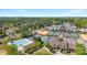 Aerial view of a community pool, tennis courts, clubhouse and wooded area at 15710 Oleander Dr, Charlotte, NC 28278