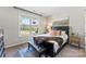 Cozy bedroom features a large window, a black accent bed, and neutral-toned walls at 15710 Oleander Dr, Charlotte, NC 28278